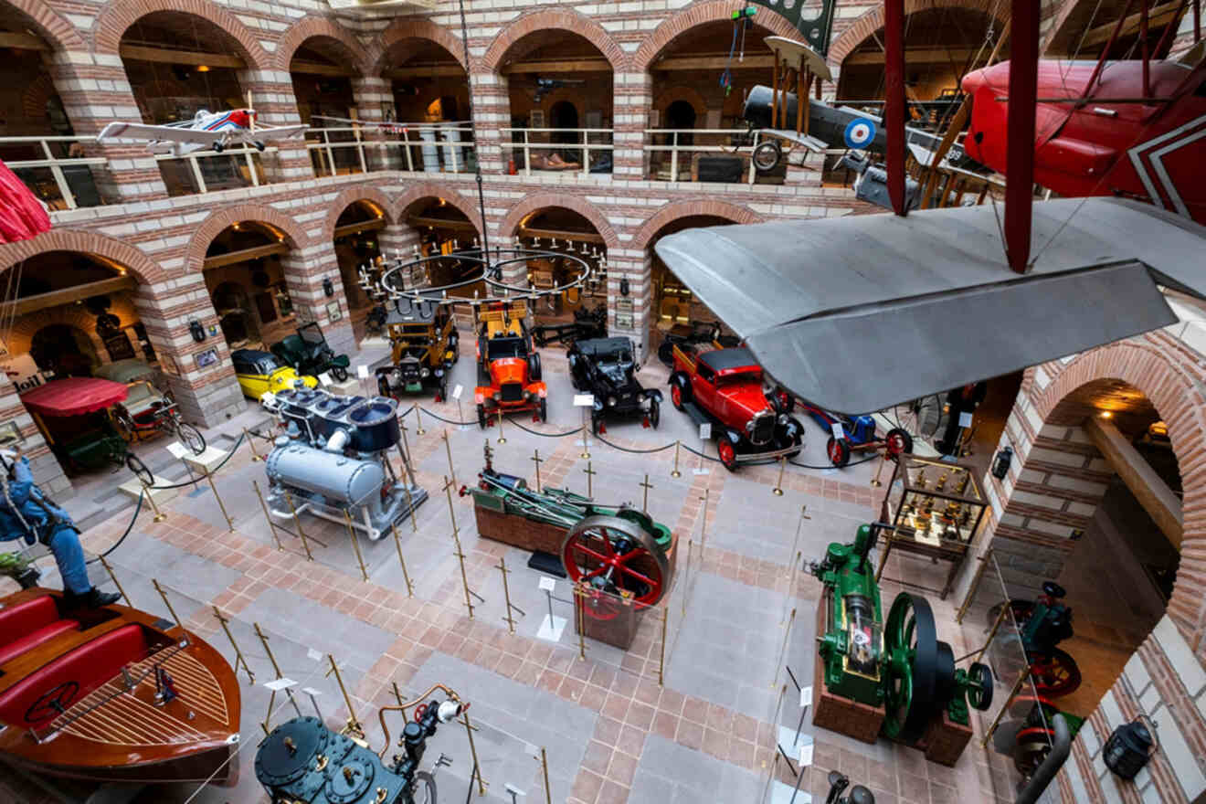 Overhead view of the Rahmi M. Koç Museum in Ankara, showcasing a diverse collection of historical vehicles, engines, and industrial machinery in a multilevel brick structure.