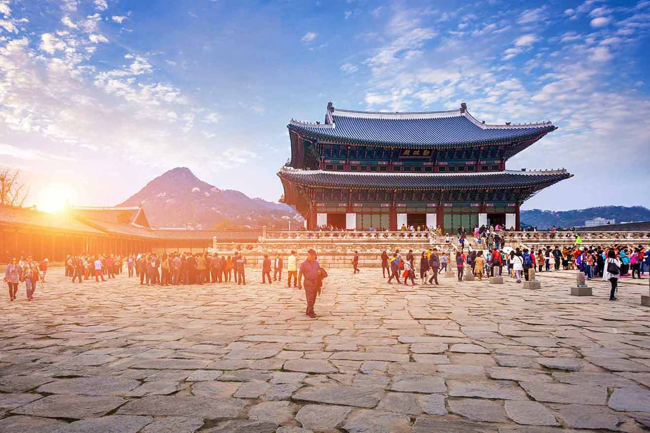 Visitors exploring the historical gyeongbokgung palace on a sunny day in seoul, south korea.