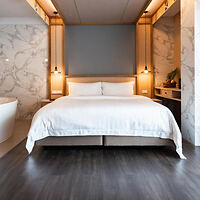 Luxurious and modern hotel room with a large bed 