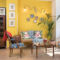 An inviting corner in a boutique hotel with a sunny yellow wall