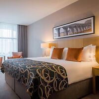 A room in the Clayton Hotel Belfast with a sophisticated decor featuring a comfortable bed