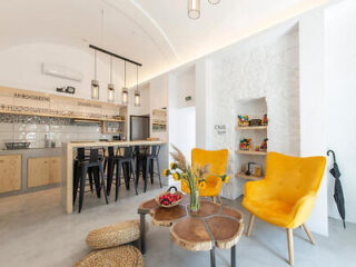 Chic and minimalist design in a communal area with vibrant yellow chairs