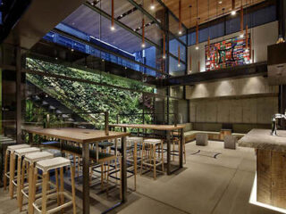 A chic bar area in a contemporary hotel with a vertical garden wall