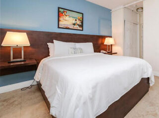 Inviting hotel bedroom with a large comfortable bed and decorative headboard