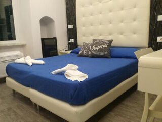 Elegant bedroom with a plush king-size bed adorned with a blue bedsheet