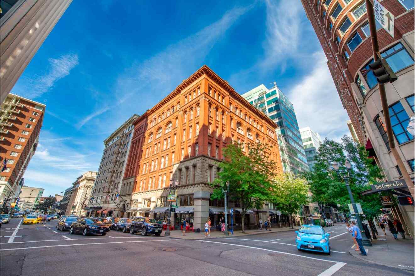 Historic red brick building in downtown Portland with vibrant city life and clear blue skies.
