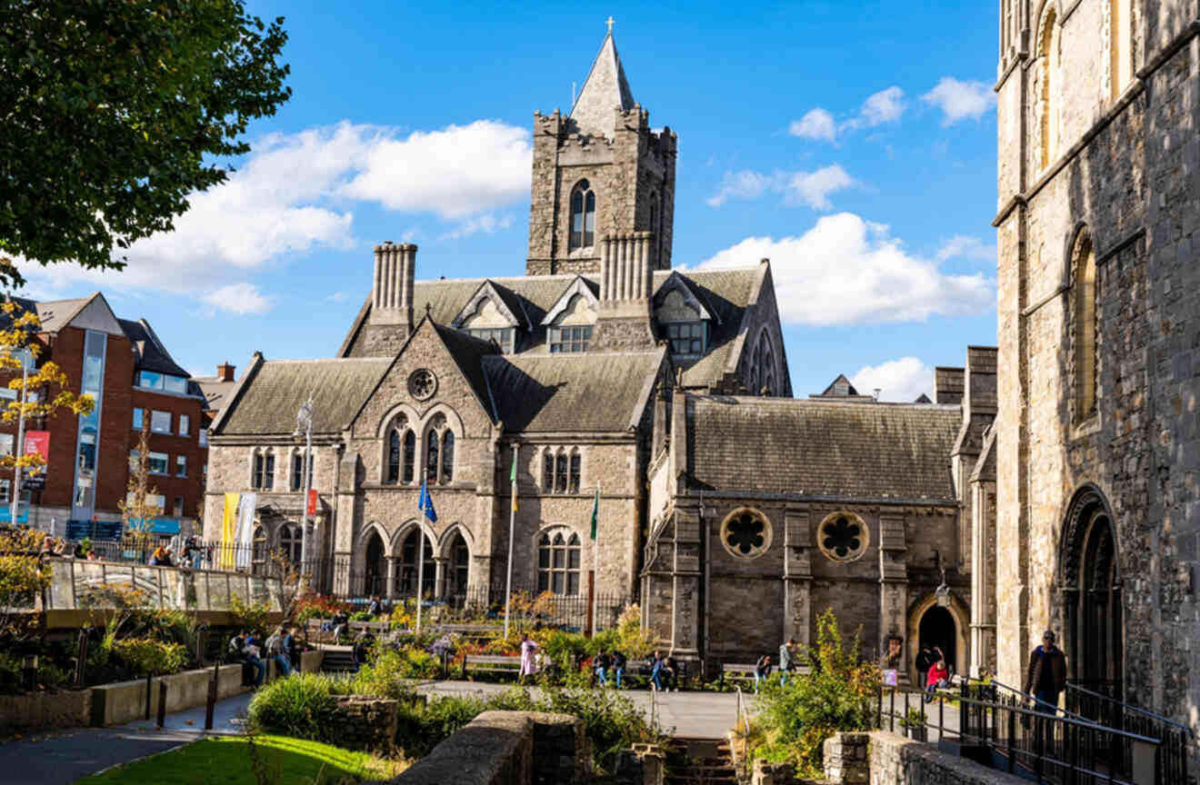 The historical Christ Church Cathedral in Dublin, captured from a street view with people walking by, highlighting the cathedral's Gothic architecture and Dublin's cultural heritage.