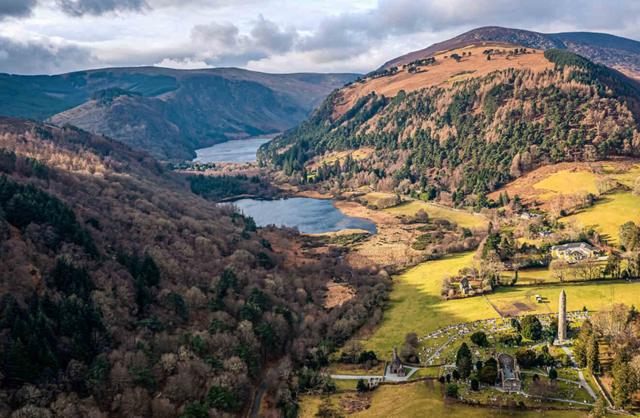Aerial view of the picturesque Glendalough Valley near Dublin, with lakes, a monastic site, and autumn-colored forests.
