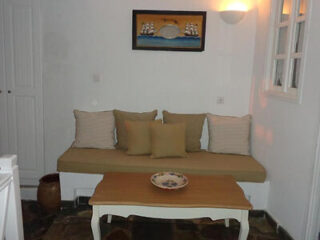 Lounge area, furnished with a comfortable built-in sofa and tasteful decor
