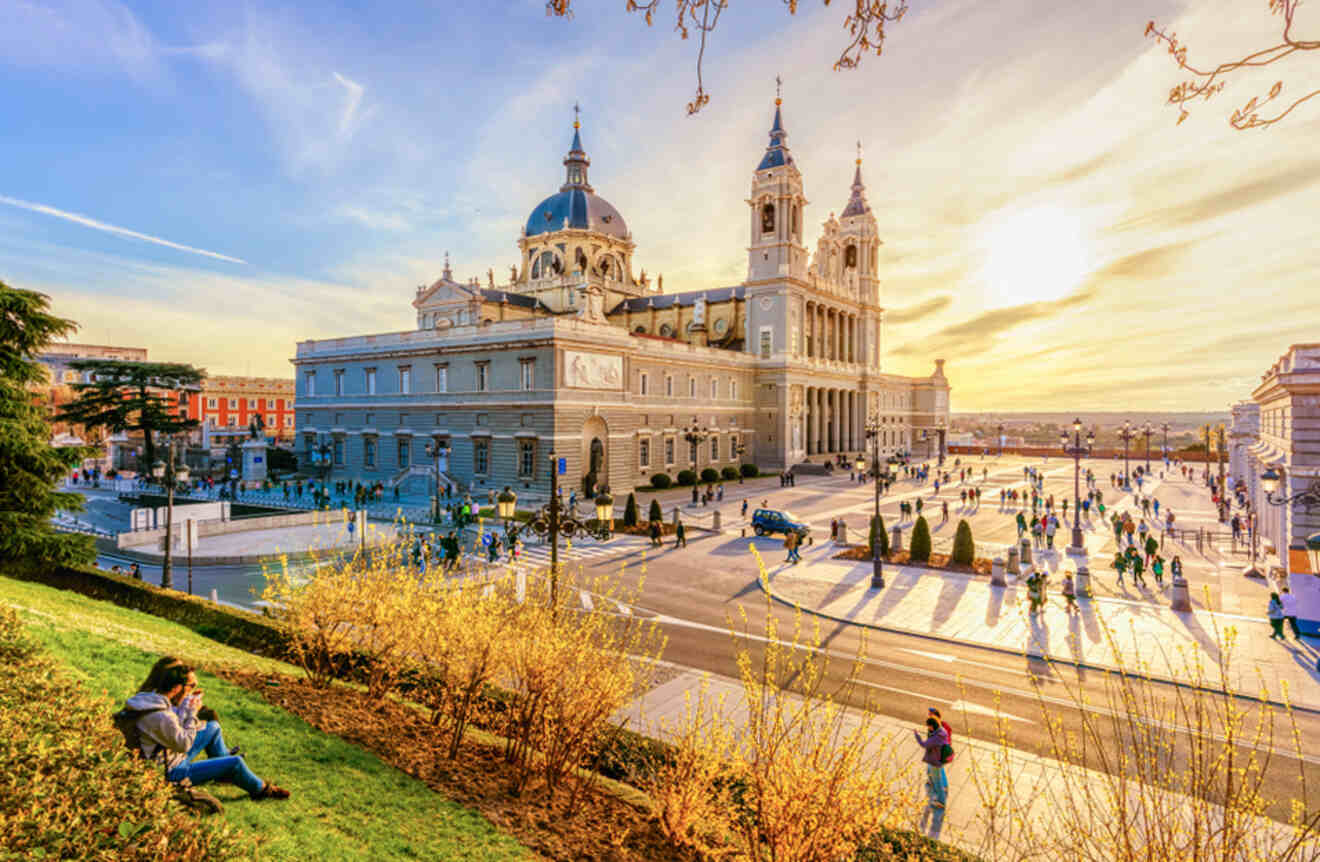 The Almudena Cathedral in Madrid, with its dual spires and domed roof, basking in the golden glow of sunset