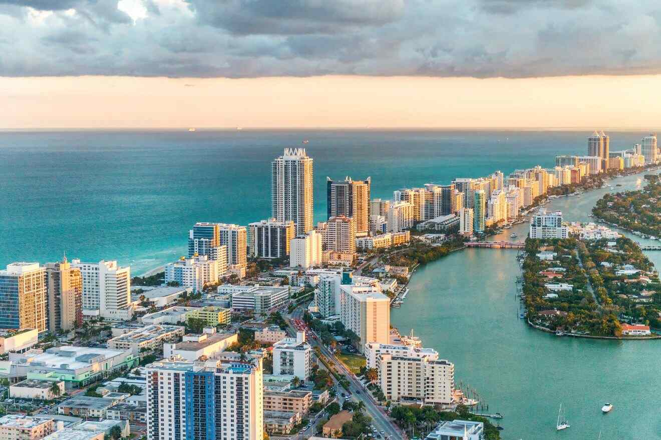 Miami's Mid-Beach area during sunset with its serene atmosphere, highlighted by high-rise buildings along the shoreline.