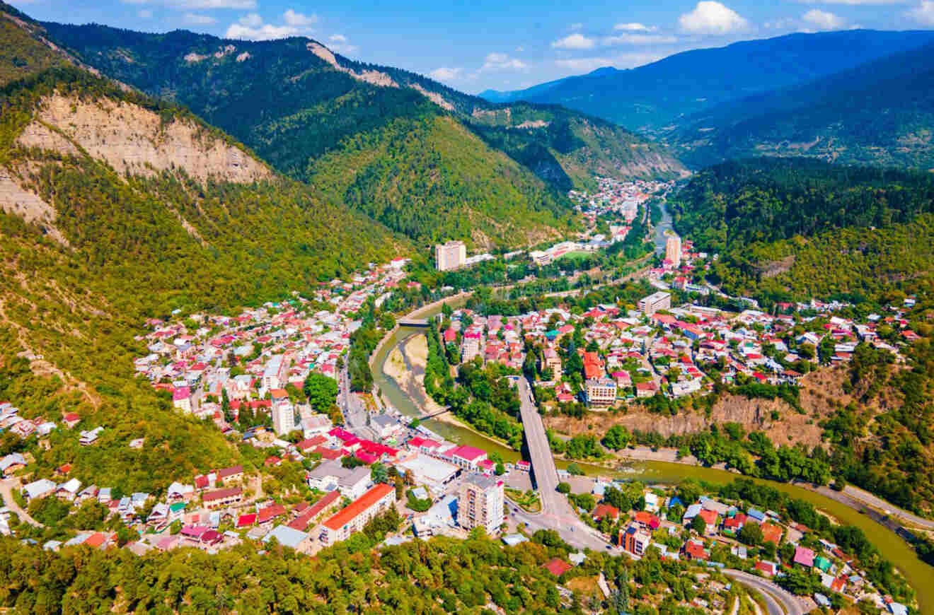 A view of Borjomi's natural beauty, with a modern building featuring unique circular architecture, surrounded by the dense forest typical of this resort town.