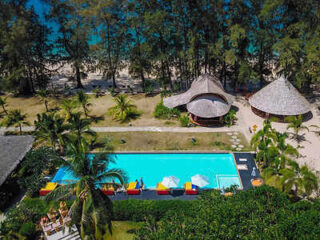 Aerial view of a Krabi beach resort pool surrounded by palm trees and thatched-roof structures