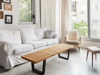 Bright and airy living space with a white sofa and wood-slatted coffee table