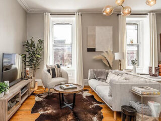 Elegant and airy living room with a light gray sectional, a cowhide rug, and tasteful decor