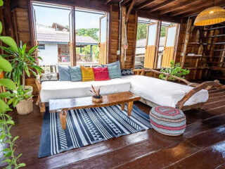 Cozy wooden interior of a Krabi beach house with rustic furniture and vibrant cushions
