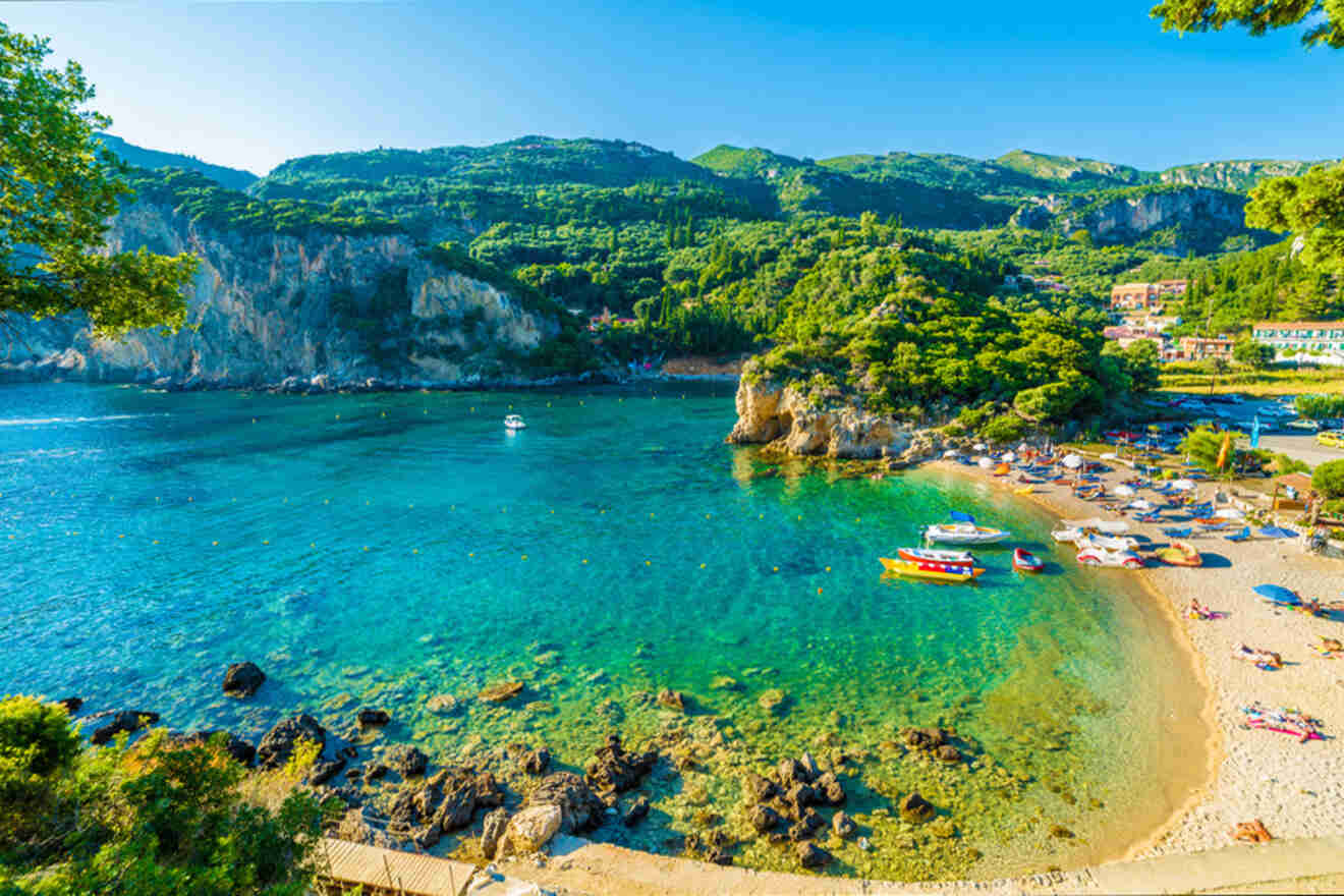 Sun-drenched cove with crystal-clear waters, a sandy beach dotted with colorful boats, surrounded by verdant hills and rugged cliffs, inviting a serene escape.