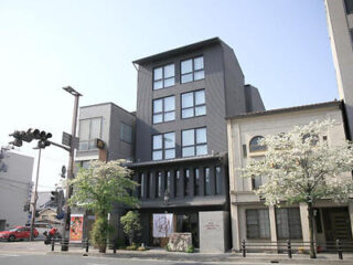 Exterior view of a modern hotel in Kyoto with a grey facade