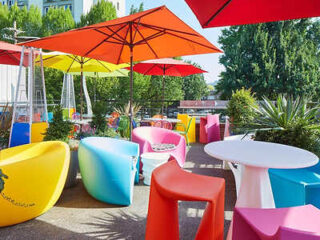 Colorful outdoor patio with bright umbrellas and modern furniture
