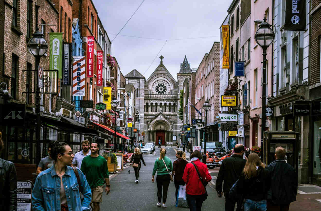 A street-level view capturing the vibrant urban life on a walking tour of Dublin, featuring historic architecture and city dwellers.