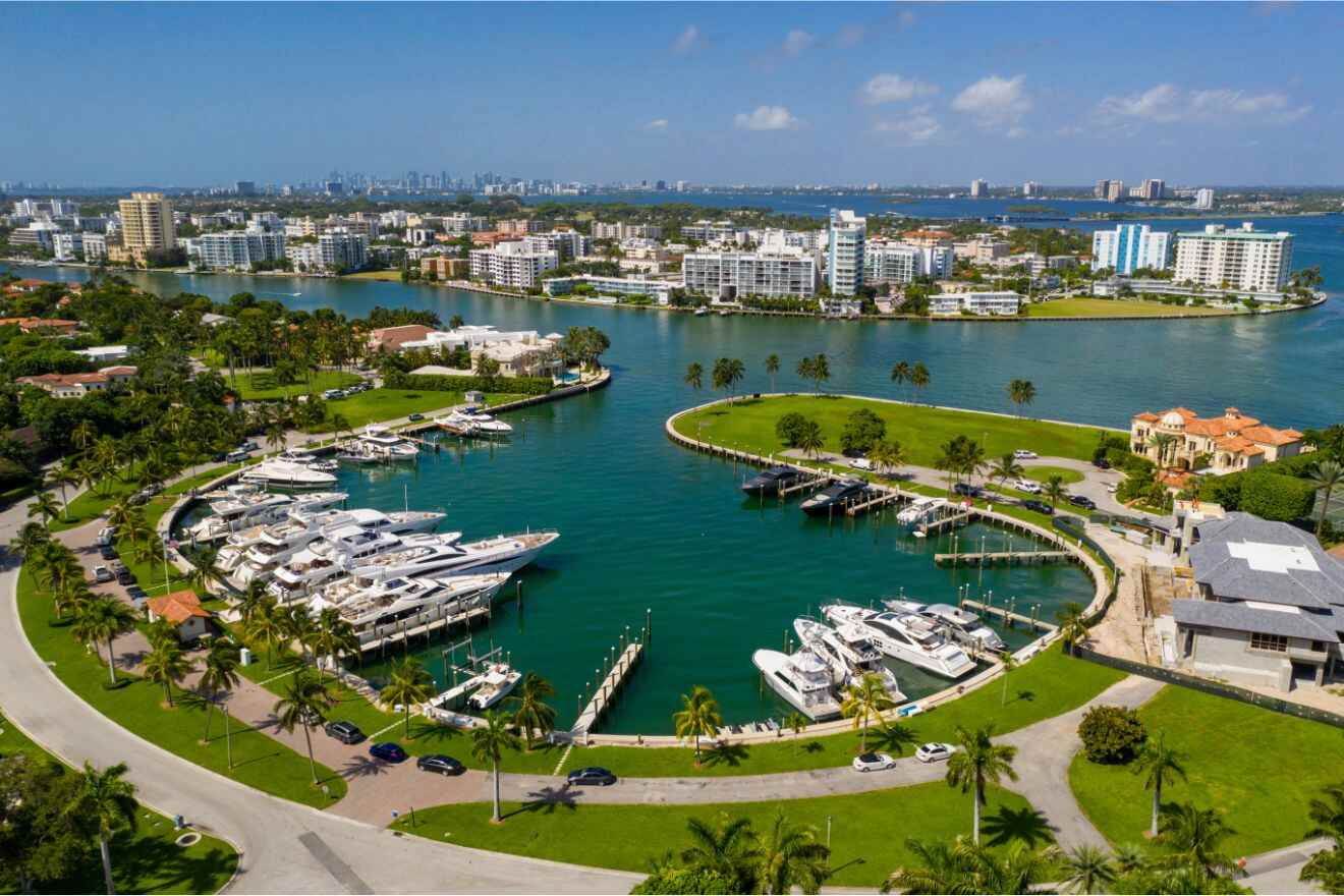 Exclusive North Beach & Bal Harbour area with luxury yachts docked in a marina, surrounded by upscale residences and verdant landscaping