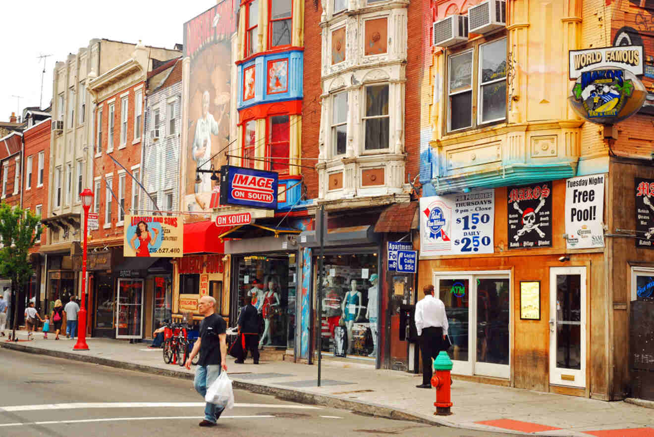 Eclectic street scene in South Philly showcasing diverse storefronts and signs, highlighting the area's vibrant and food-centric culture