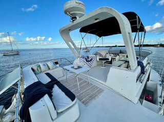 Deck of a luxury yacht with comfortable seating and a panoramic view