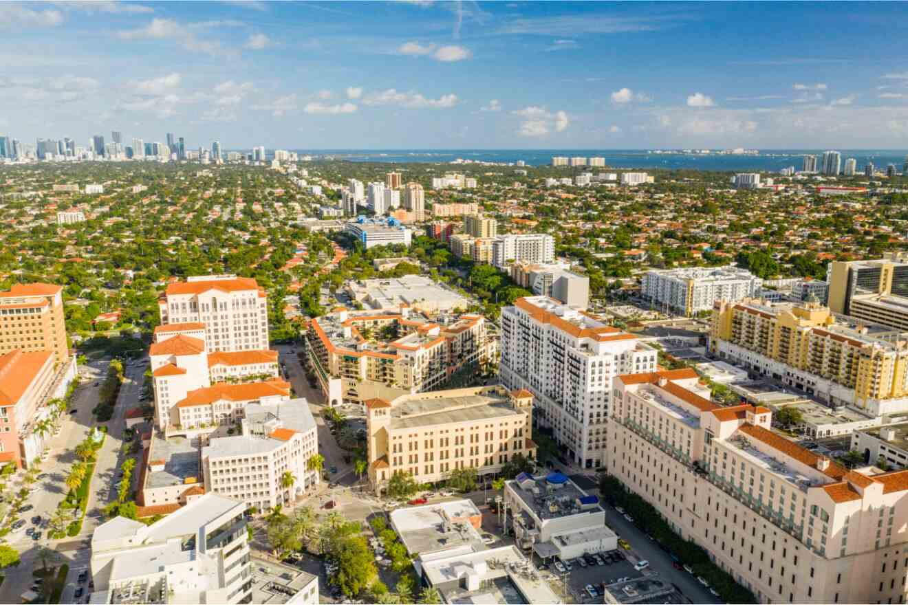 Aerial view of Coral Gables, Miami, with its characteristic Mediterranean-style buildings surrounded by lush greenery