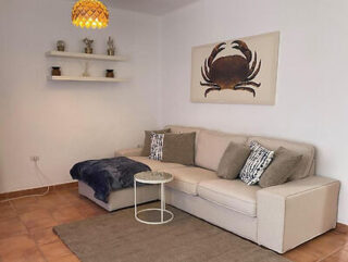 Comfortable living space with a sectional sofa, modern art, and warm lighting