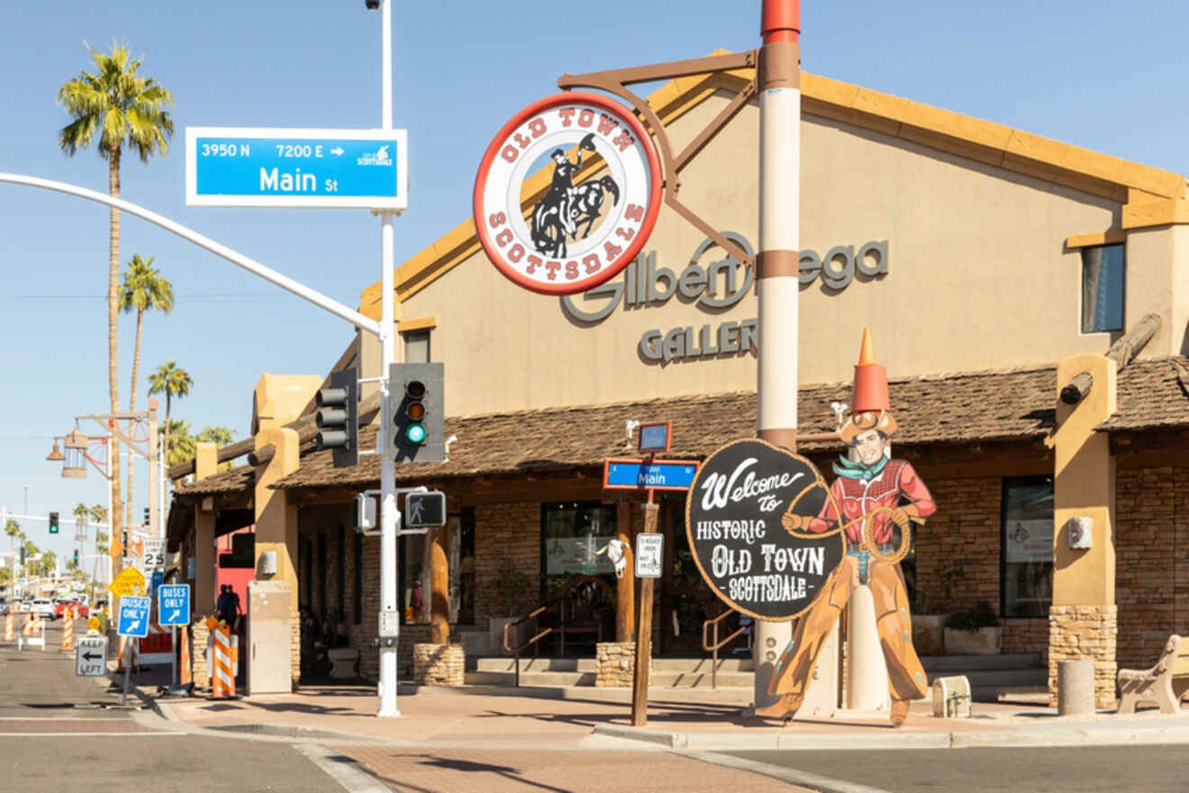 A street view of Old Town Scottsdale featuring a "Welcome to Historic Old Town Scottsdale" sign and a cowboy statue