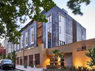 A contemporary hotel building with sleek lines, large windows, and a well-maintained exterior.