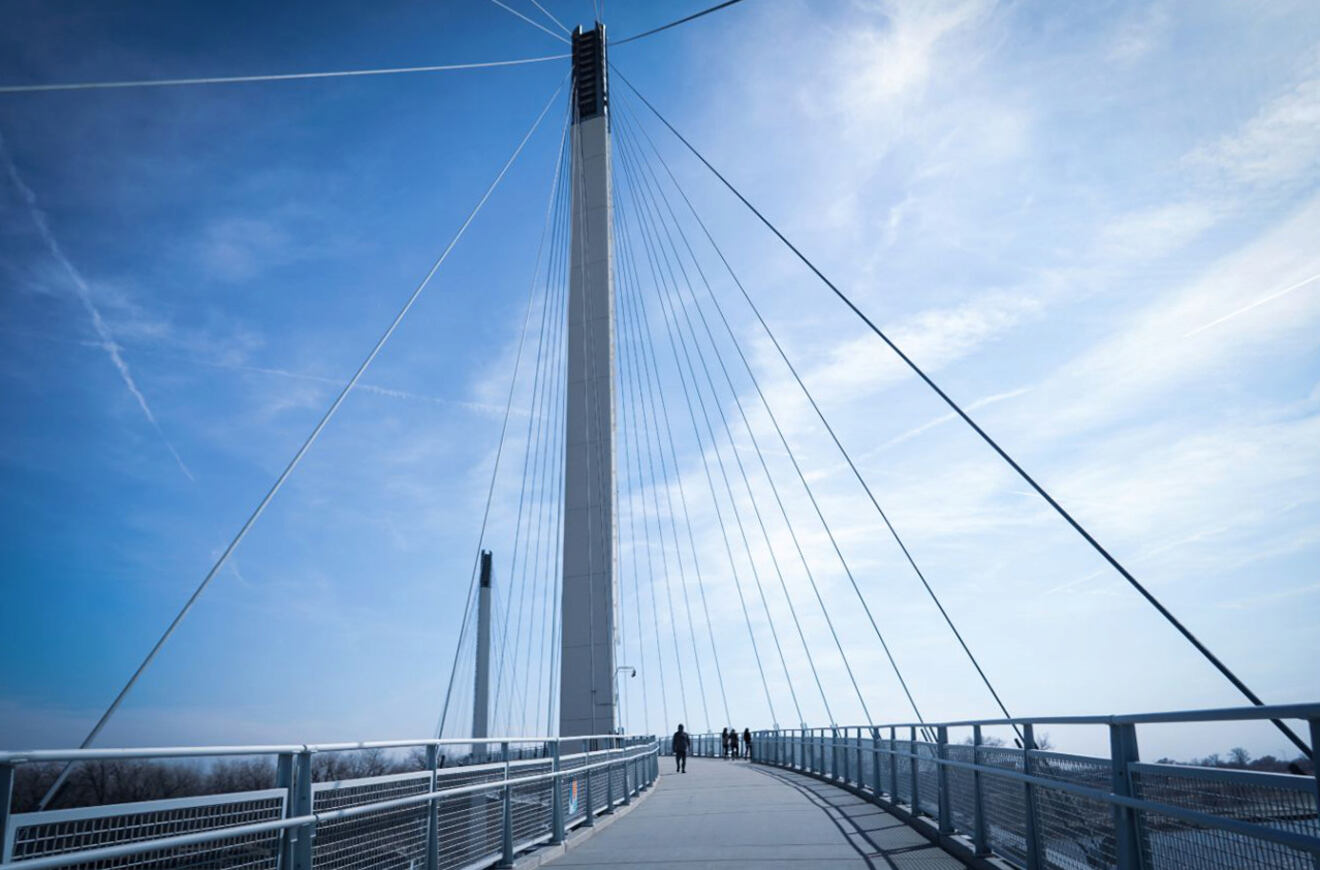 The Bob Kerrey Pedestrian Bridge with its tall cables against a blue sky