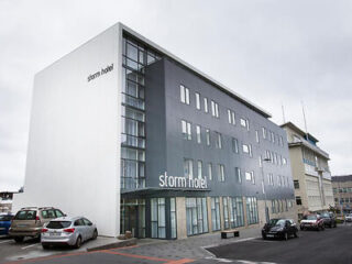 The exterior of Storm Hotel, a contemporary building with a minimalist design, located in an urban setting.