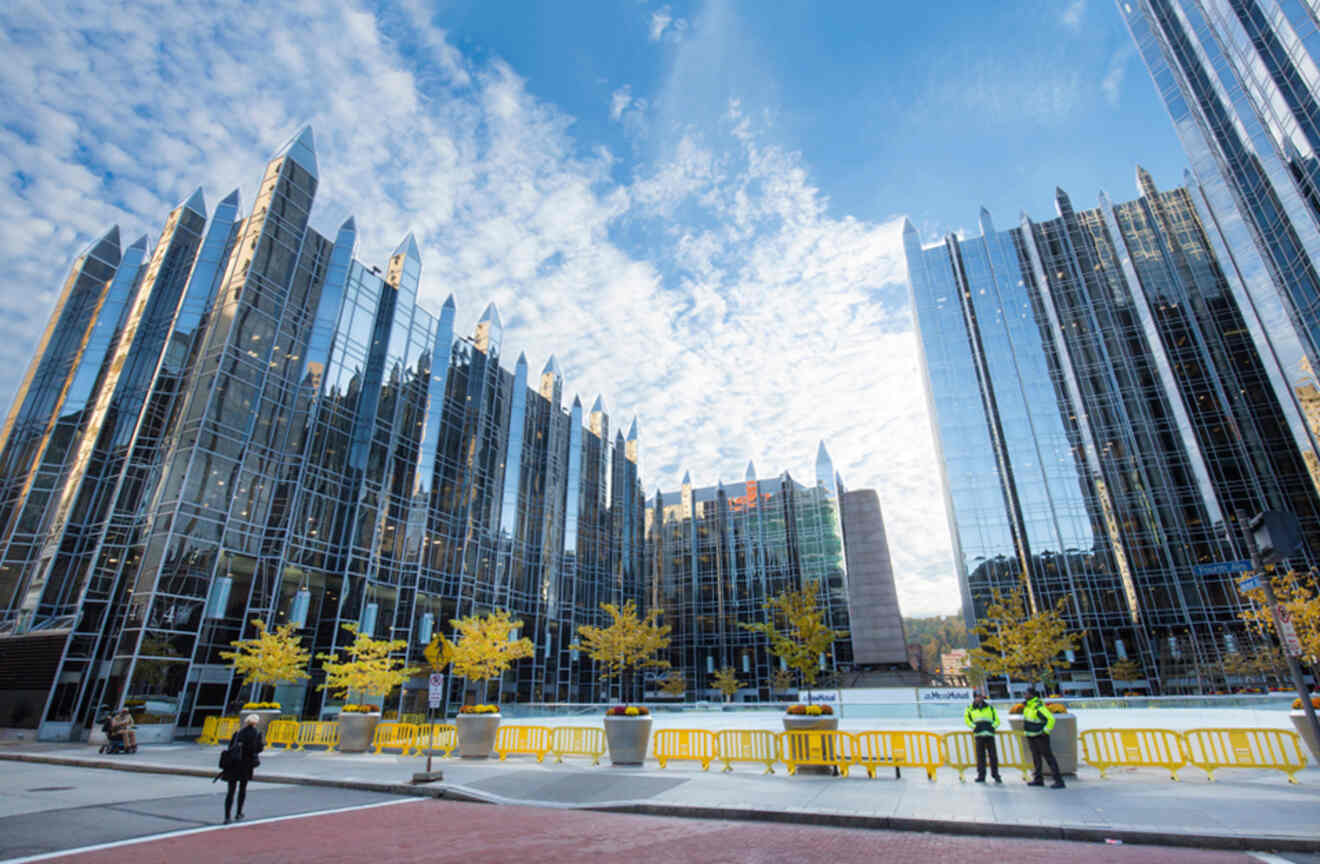 The reflective glass towers of the PPG Place complex with a blue sky overhead.