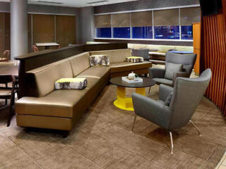 A modern lounge area with stylish seating and a large wrap-around couch.