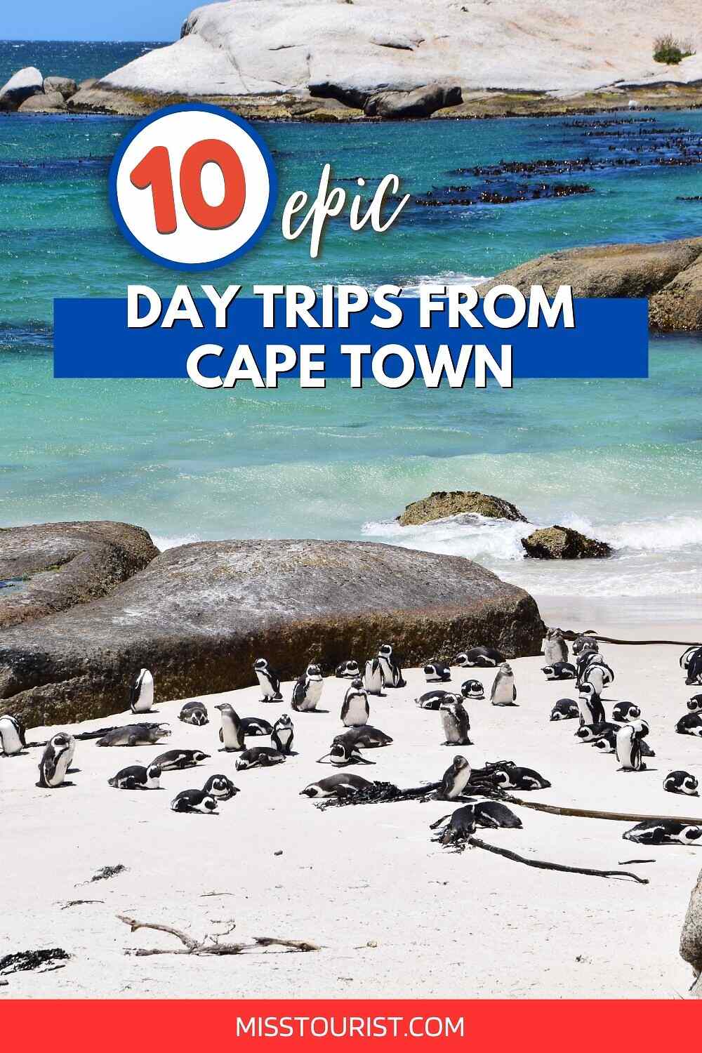A sign reading "10 epic day trips from Cape Town" is shown above a beach with numerous penguins, rocks, and turquoise ocean water in the background. The URL "MISSTOURIST.COM" appears at the bottom.