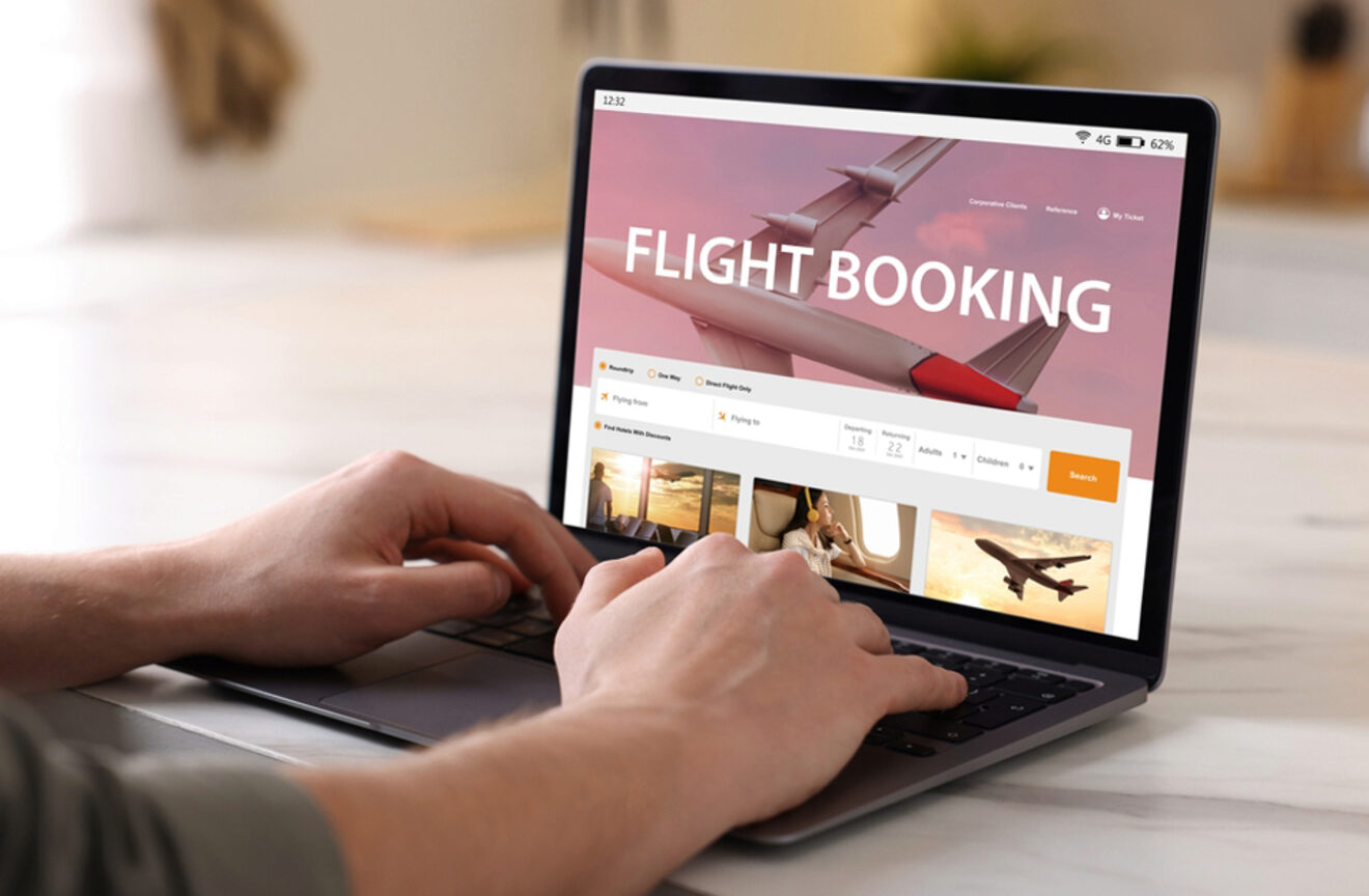 Person using a laptop to book a flight on an online flight booking website.