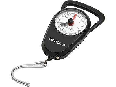 A black Samsonite luggage scale with a white dial and a metal hook is shown. The dial has black and red markings to indicate weight.
