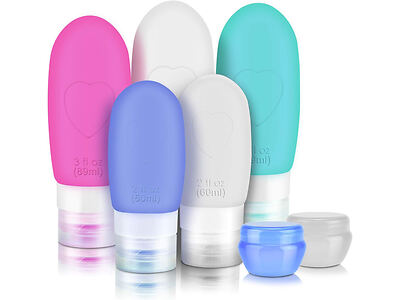 Five colorful silicone travel bottles and two small jars, used for storing toiletries. The bottles have screw-on caps and come in pink, purple, white, teal, and blue.