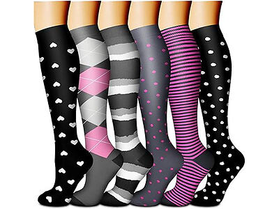 Six pairs of knee-high socks with various patterns: hearts, argyle, stripes, polka dots, and combinations in black, gray, pink, and white colors.
