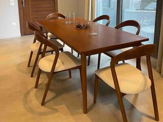Modern dining area with a wooden table and six matching chairs.