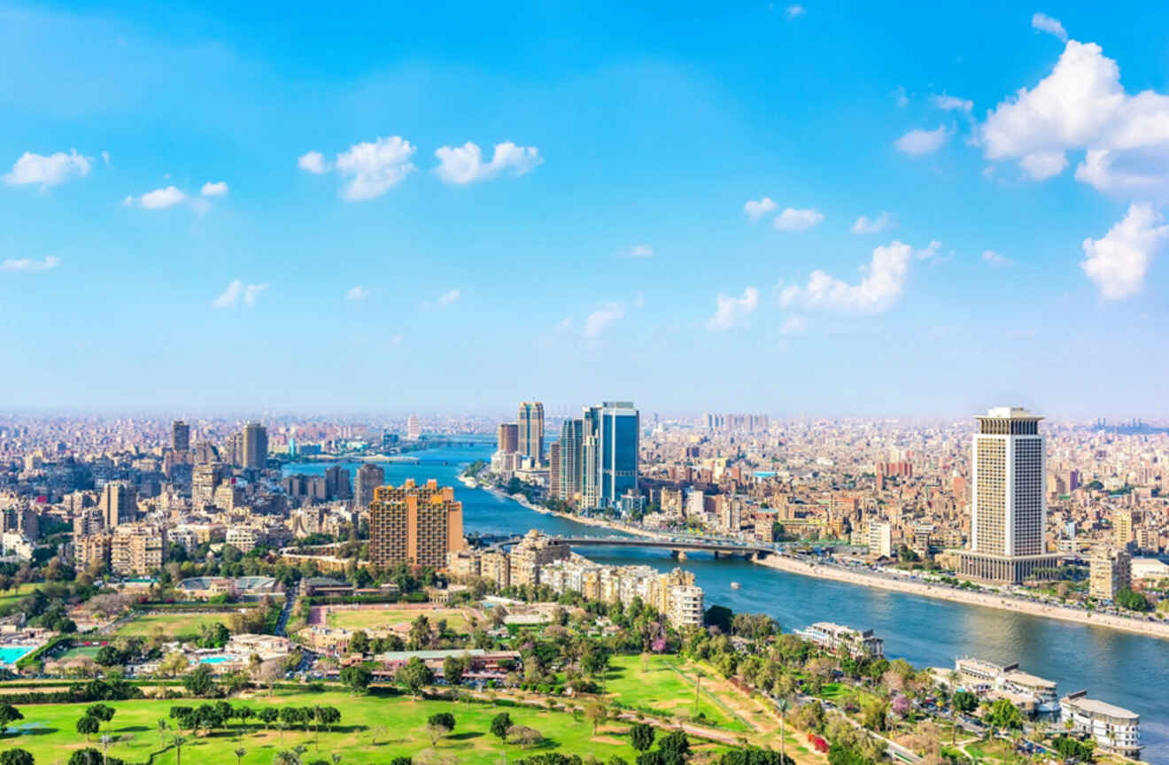 Aerial view of Cairo with a river running through the city and high-rise buildings.