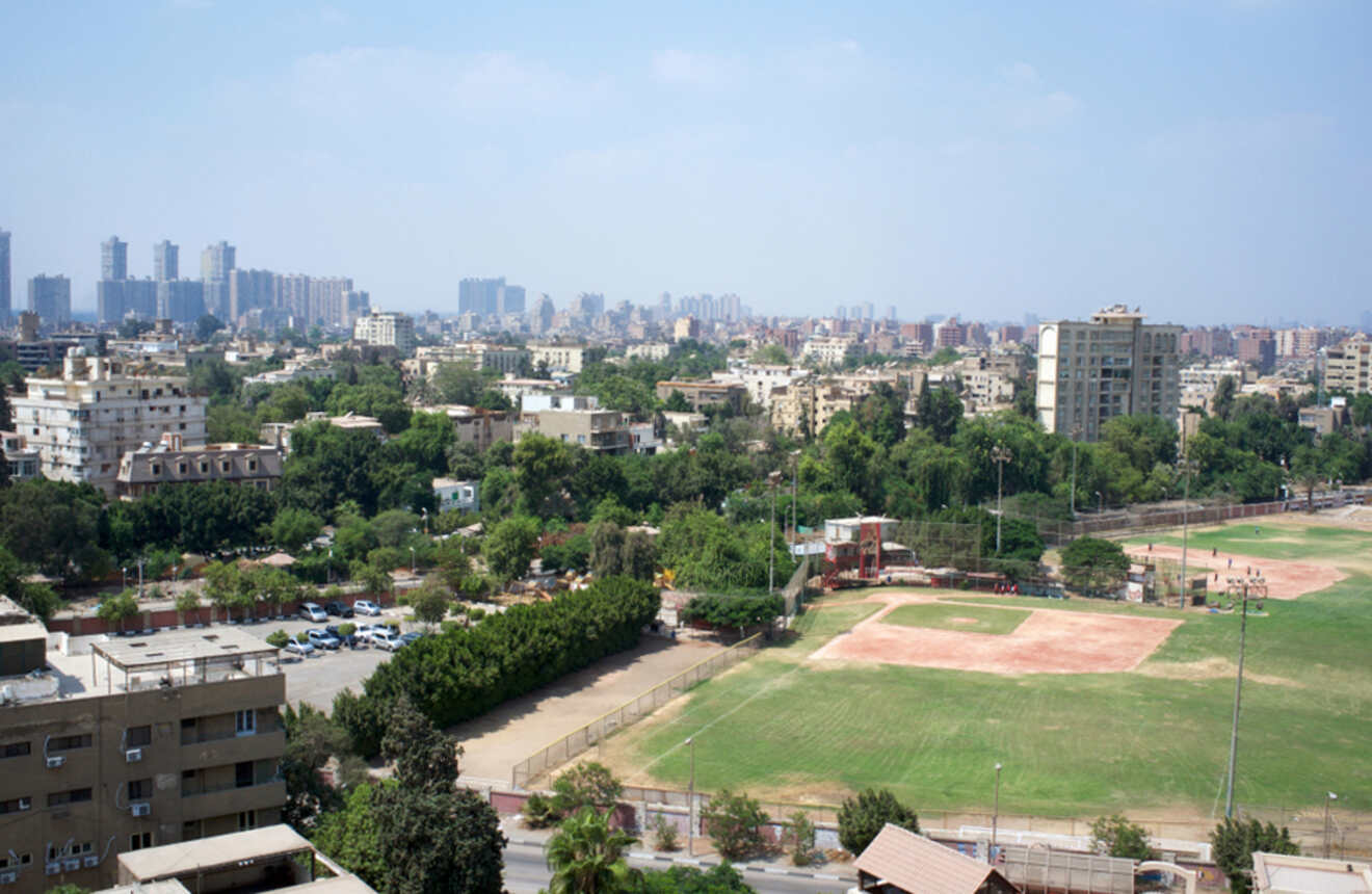 Aerial view of a green urban area in Cairo with residential buildings and parks.