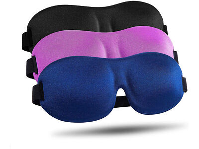 Three foam eye masks in black, pink, and blue are displayed in a row, showcasing their contoured shapes and adjustable straps.