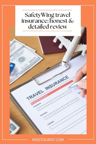 Clipboard with a travel insurance form, documents, model airplane, money, and a pen. The image promotes a review of SafetyWing travel insurance.