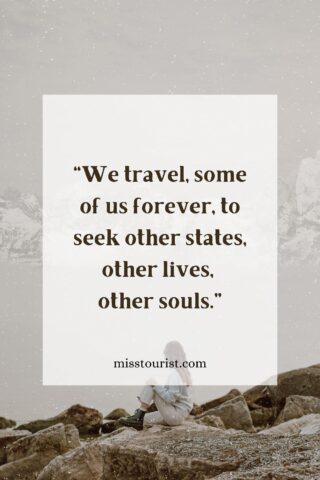 Image of a person sitting on rocks by the water with mountains in the background, with the quote "We travel, some of us forever, to seek other states, other lives, other souls." and the website "misstourist.com" displayed on the image.