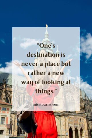 Image of a person in a red dress standing in front of a cathedral with arms outstretched, with the quote "One’s destination is never a place but rather a new way of looking at things." and the website "misstourist.com" displayed on the image.