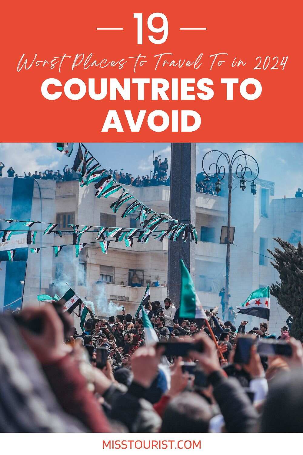 Image of a crowded street scene with many people holding up flags. The text overlay reads "19 Worst Places To Travel To in 2024: Countries to Avoid," attributed to MissTourist.