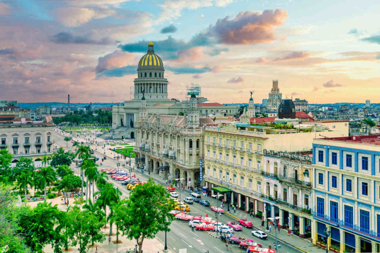 A cityscape of Havana, Cuba, featuring the Capitolio building with a golden dome, surrounded by historical architecture, lush green trees, and colorful vintage cars on the streets.