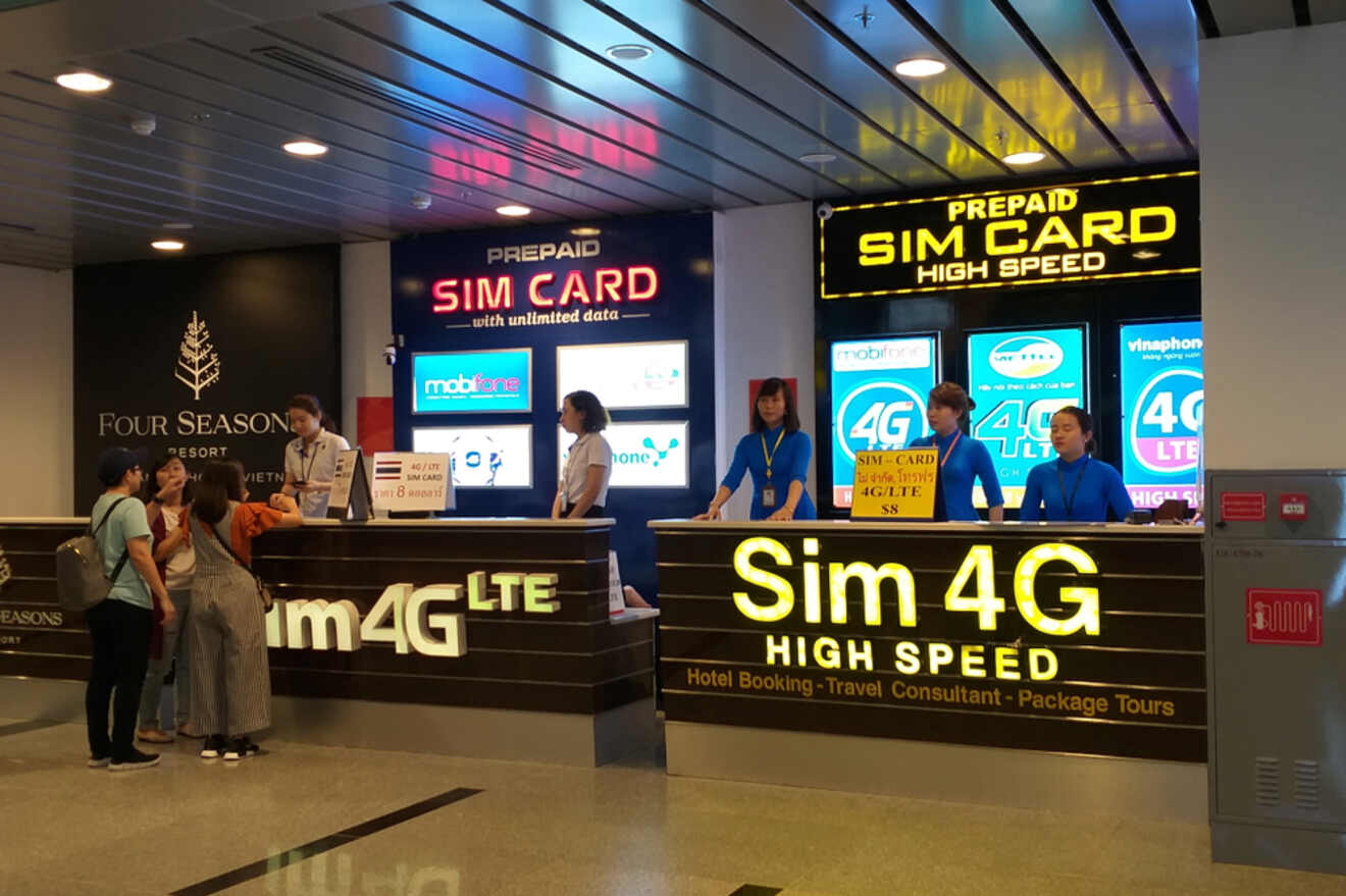 A SIM card shop with bright signs advertising prepaid SIM cards with unlimited data, with customers and staff interacting at the counter.